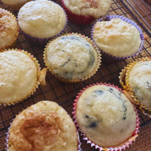 freshly baked pancake muffins on a cooling rack and dish towel.